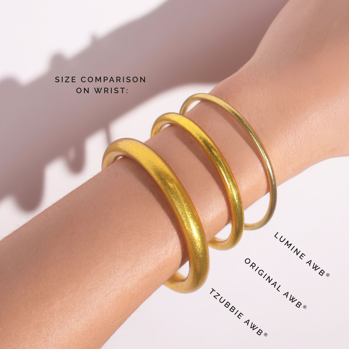 a person wearing gold bracelets