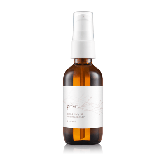 Amber glass bottle with a white pump dispenser containing Bath & Body Oil | Privai, featuring a minimalist label with delicate botanical design for skincare and body care.