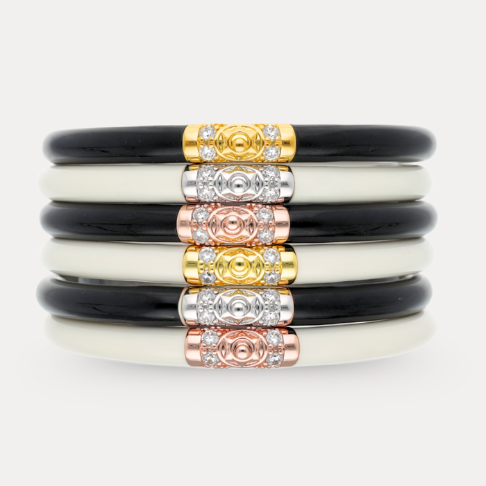 a stack of black and white bracelets
