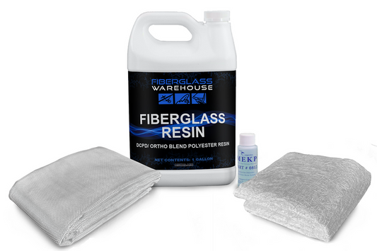 Gallon of fiberglass resin next to folded fiberglass cloth and chopped strand mat.