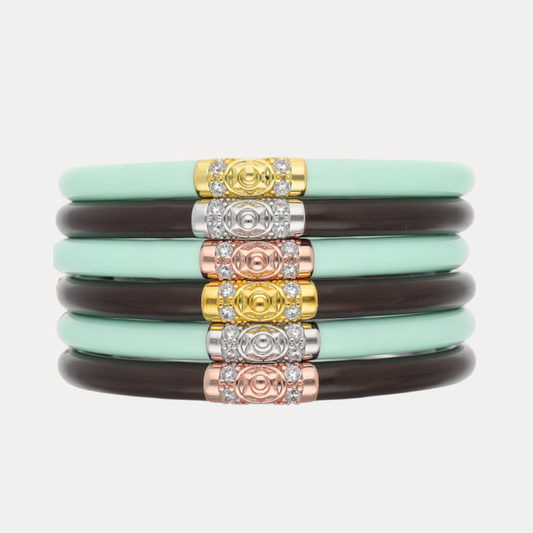 a stack of bracelets with different colored bands