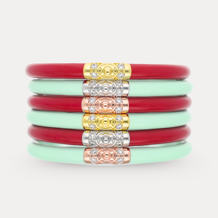 a stack of red and green bracelets