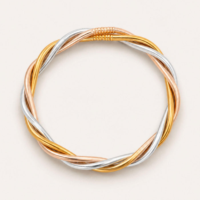 Trilogy All Weather Bangle® featuring intertwined gold, silver, and champagne colors symbolizing elegance.